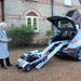 ComfyGO Quingo Flyte Mobility Scooter With MK2 Self Loading Ramp In Action going up to the car